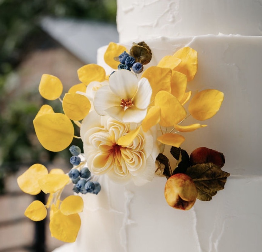Hand-painted sugar flowers with golden eucalyptus leaves and blueberries